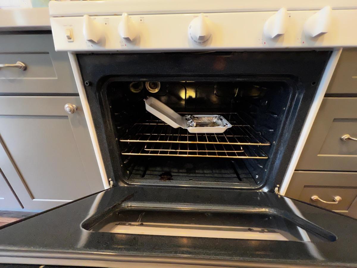 Oven interior with leftover food before cleaning