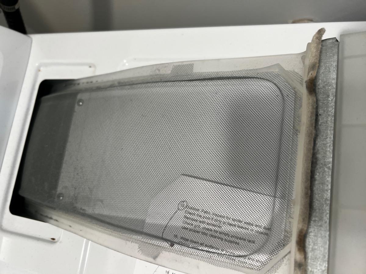 Clogged dryer lint trap before maintenance check
